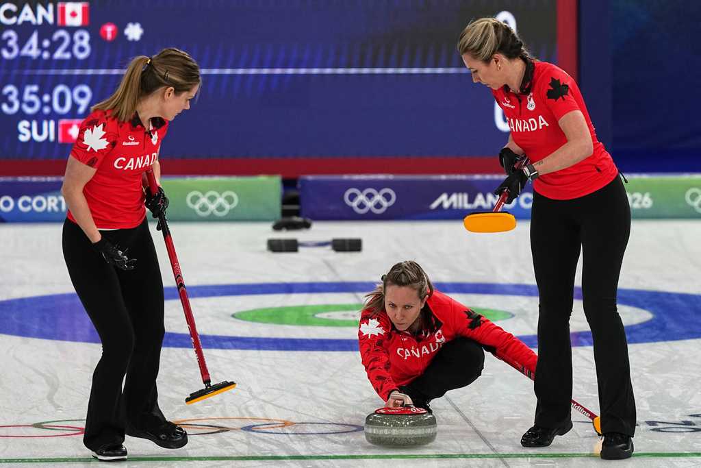 Canada&amp;apos;sS arah Wilkes, Rachel Homan and Emma Miskew in action during the women&amp;apos;s curling round robin session against Switzerland at the 2026 Winter Olympics, in Cortina d&amp;apos;Ampezzo, Italy, Saturday, Feb. 14, 2026. (AP Photo/Fatima Shbair)