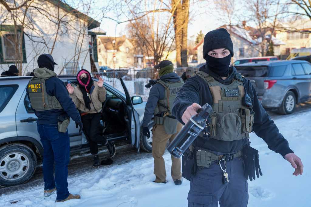Activists are approached by federal agents for following agent vehicles, on Tuesday, Feb. 3, 2026, in Minneapolis. (AP Photo/Ryan Murphy)