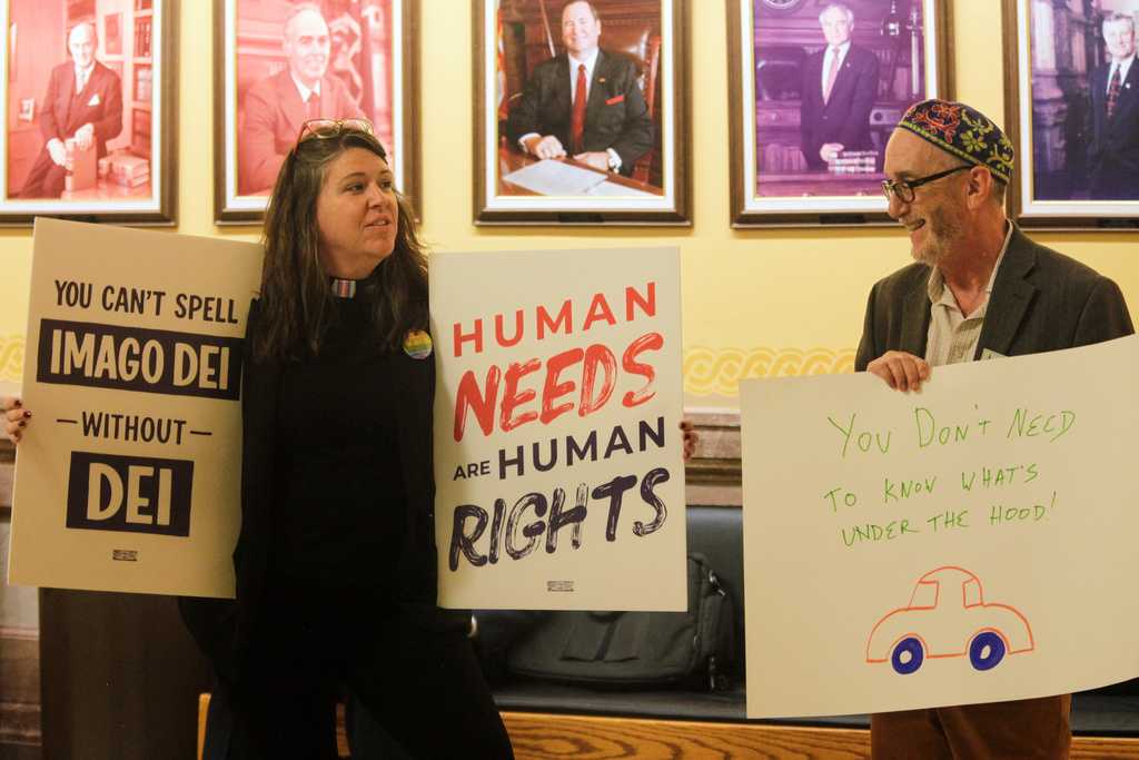 The Rev. Dr. Mandy Todd, left, pastor of Messiah Lutheran Church in Lindsborg, Kan., and Rabbi Moti Rieber, right, executive director of Kansas Interfaith Action, protest a new Kansas law that will invalidate hundreds of driver&amp;apos;s licenses and birth certificates for transgender people that reflect their gender identities, Monday, Feb. 16, 2026, outside the Kansas Senate chamber in the Statehouse in Topeka, Kan. (AP Photo/John Hanna)