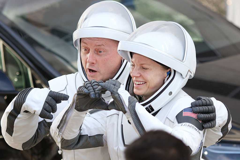 (L/R) Crew-11 mission members NASA astronaut Mike Fincke and NASA astronaut and mission commander Zena Cardman gesture to family and supporters as they depart the Neil A. Armstrong Operations and Checkout Building en route to launch complex LC-39A at the Kennedy Space Center in Cape Canaveral, Florida on August 1, 2025. (Photo by Gregg Newton / AFP) (Photo by GREGG NEWTON/AFP via Getty Images)          