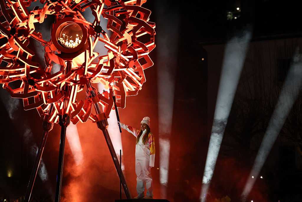 TOPSHOT - Italian alpine skier Sofia Goggia holds the Olympic torch under the Cortina cauldron during the opening ceremony of the Milano Cortina 2026 Winter Olympic Games in Cortina d&amp;apos;Ampezzo, northern Italy, on February 6, 2026. (Photo by Franck FIFE / AFP via Getty Images)