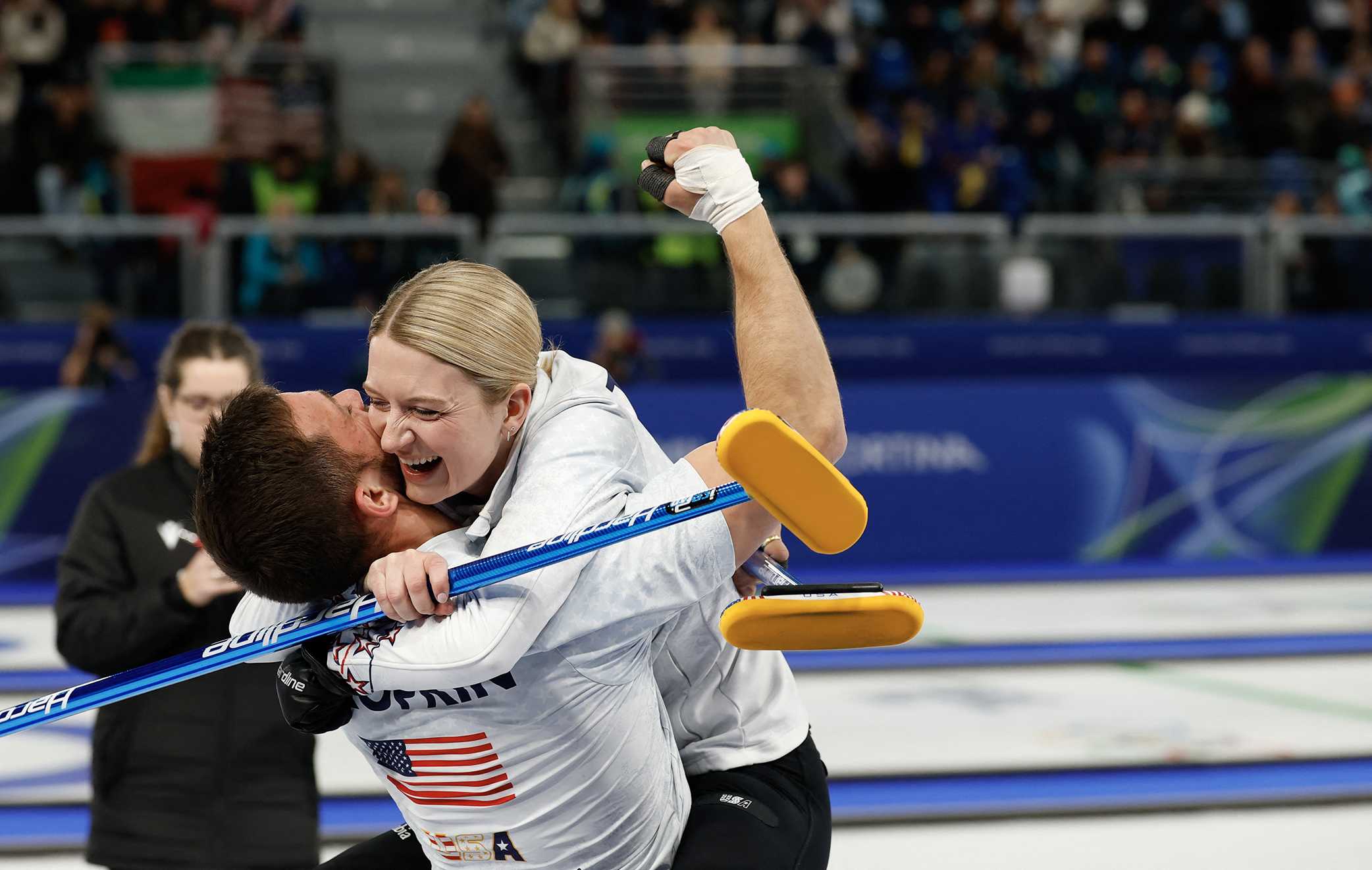 Cory Thiesse and Korey Dropkin celebrate at the end of the curling mixed doubles round robin semi-final between USA and Italy during the Milan Cortina 2026 Winter Olympic Games at the Cortina Curling Olympic Stadium in Cortina d'Ampezzo on February 9, 2026.