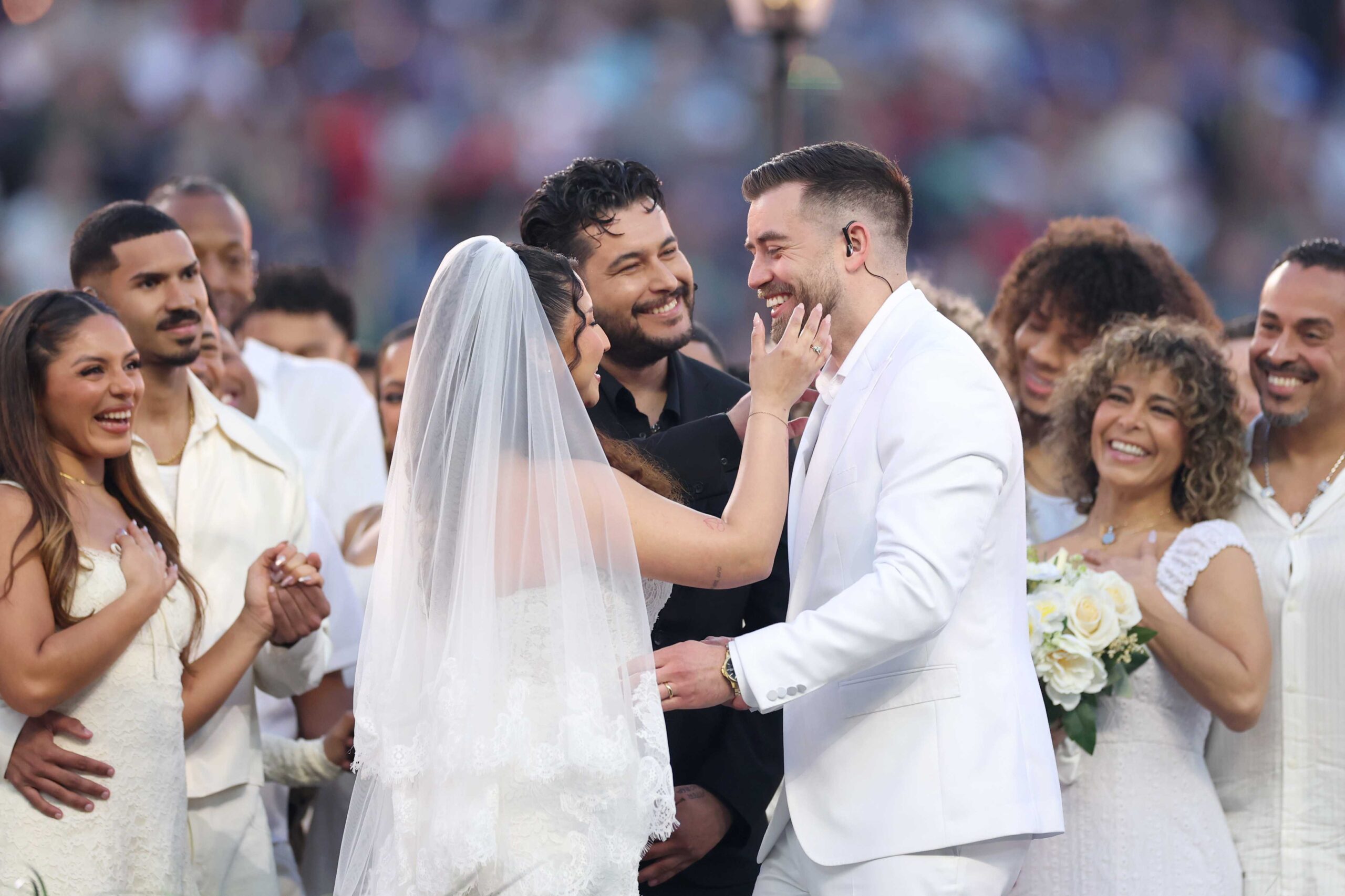SANTA CLARA, CALIFORNIA - FEBRUARY 08: A couple marries during the Bad Bunny performance onstage at the Apple Music Super Bowl LX Halftime Show at Levi&amp;apos;s Stadium on February 08, 2026 in Santa Clara, California. (Photo by Kevin C. Cox/Getty Images)