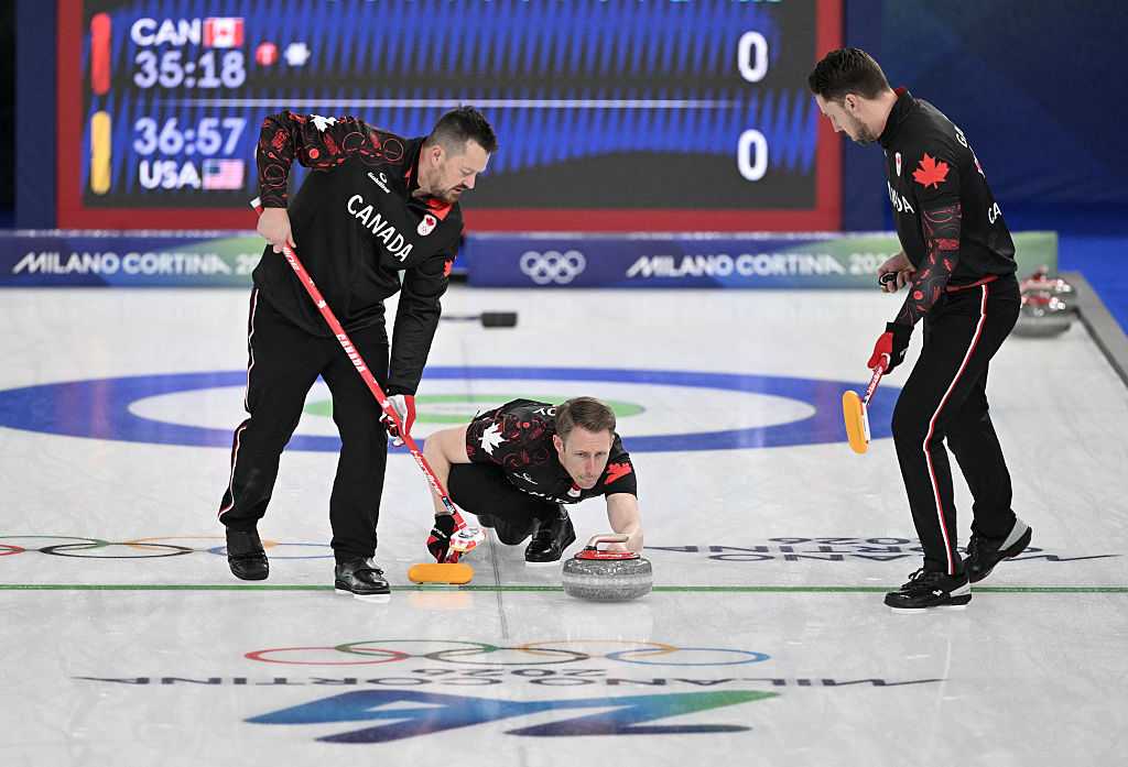 Ben Herbert (L), Marc Kennedy (C) and Brett Gallant of Team Canada compete in the curling men&amp;apos;s round robin between Canada and USA during the Milano Cortina 2026 Winter Olympic Games at the Cortina Curling Olympic Stadium in Cortina d&amp;apos;Ampezzo on February 13, 2026. (Photo by Tiziana FABI / AFP via Getty Images)
