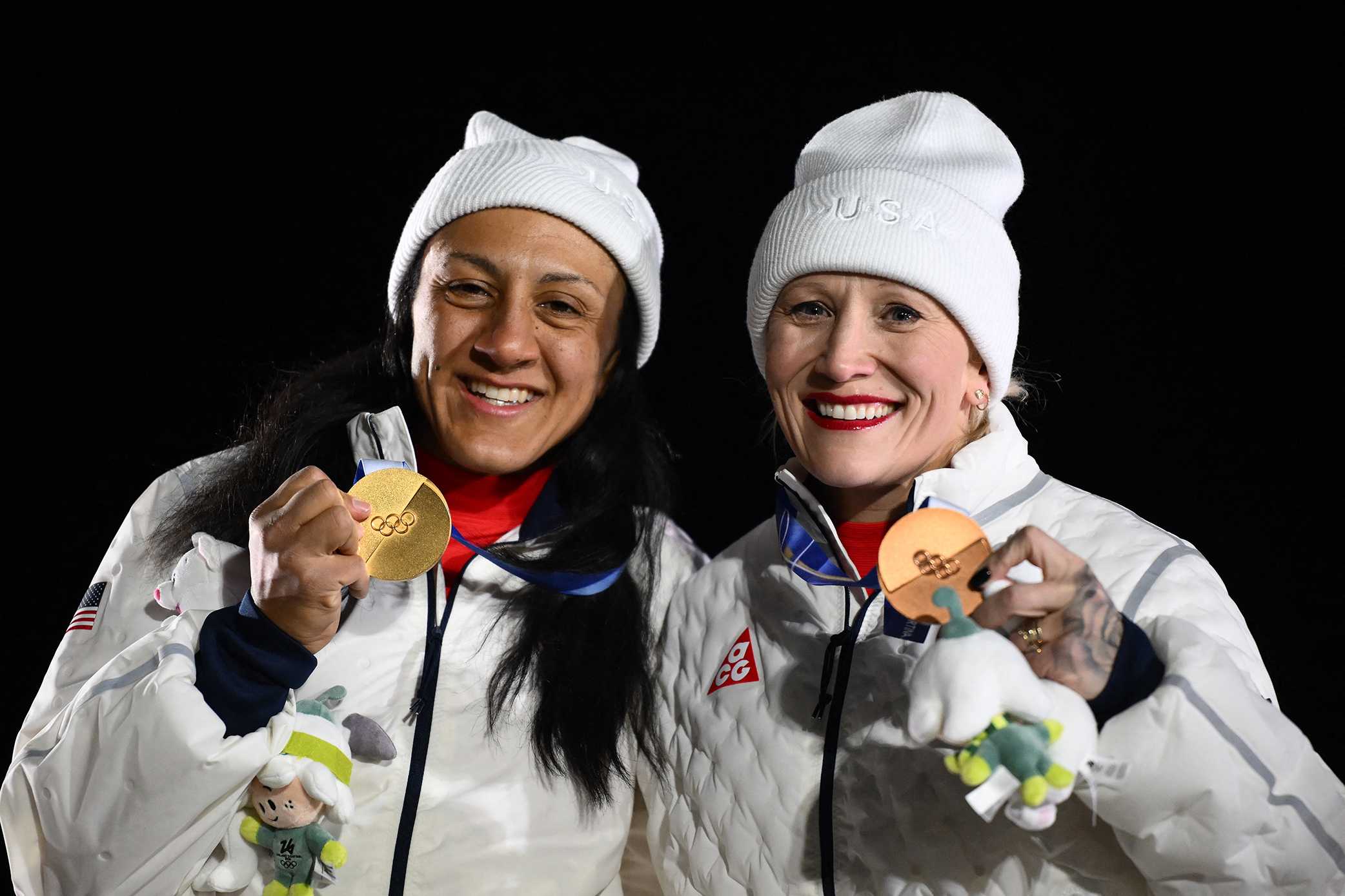 Gold medallist USA's Elana Meyers Taylor and bronze medallist USA's Kaillie Armbruster Humphries pose on the podium of the bobsleigh women's monobob at Cortina Sliding Centre during the Milano Cortina 2026 Winter Olympic Games in Cortina d'Ampezzo on Feb. 16, 2026.