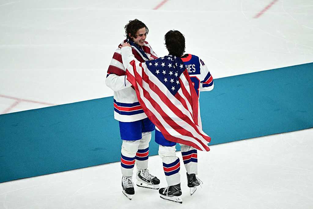 USA's #86 Jack Hughes (L) and USA's #43 Quinn Hughes  celebrate after winning during the men's gold medal ice hockey match between Canada and USA at the Milano Santagiulia Ice Hockey Arena during the Milan Cortina 2026 Winter Olympic Games in Milan, on February 22, 2026.