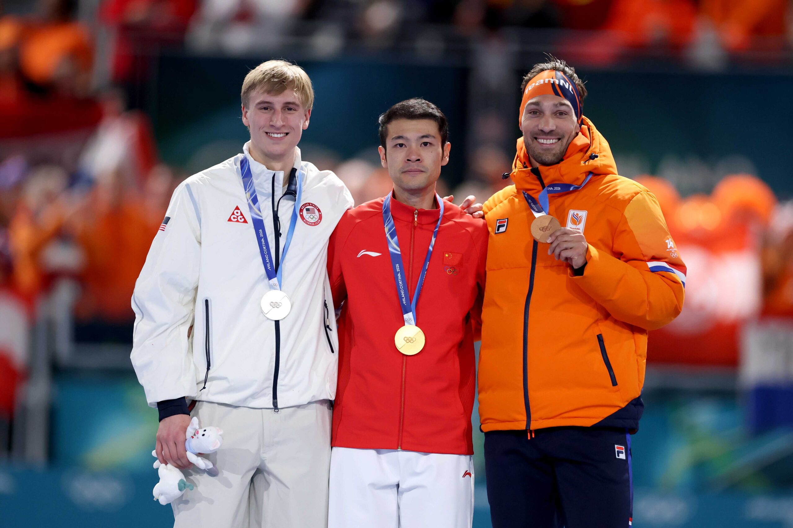 Gold medalist Zhongyan Ning of Team People's Republic of China, Silver medalist Jordan Stolz of Team United States and Bronze medalist Kjeld Nuis of Team Netherlands pose for a photo on the podium during the medal ceremony for the Speed Skating Men's 1500m on day thirteen of the Milano Cortina 2026 Winter Olympic games at Milano Speed Skating Stadium on Feb. 19, 2026, in Milan, Italy.
