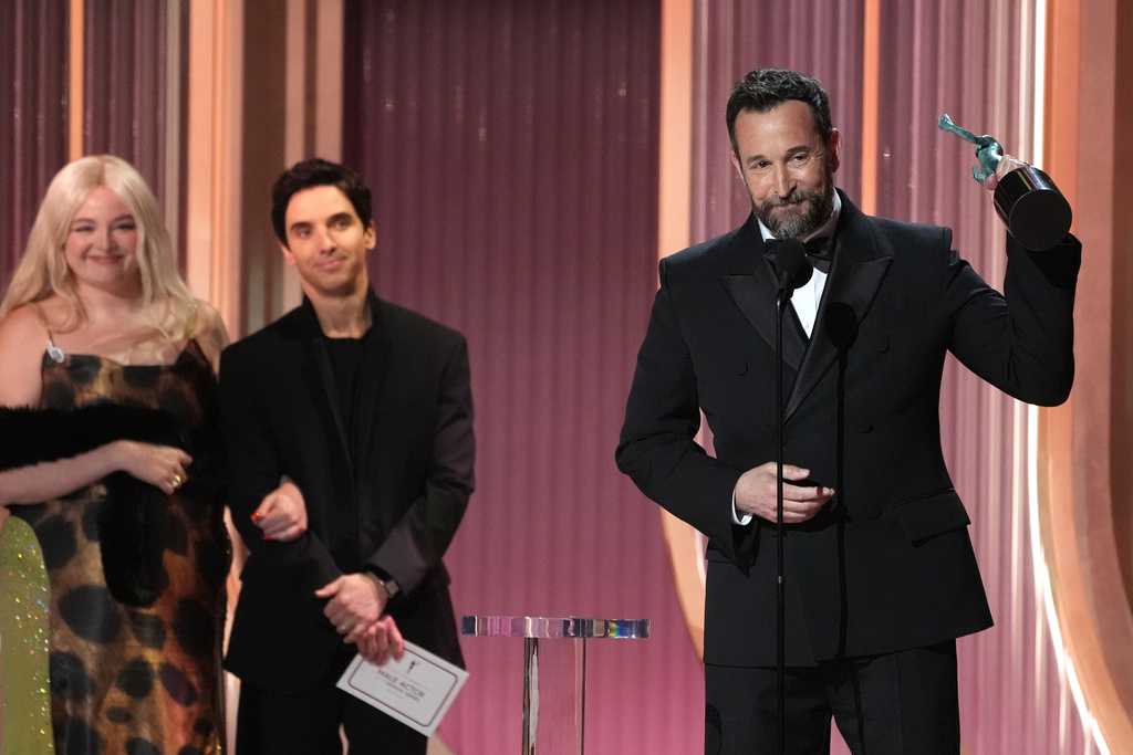 Noah Wyle, right, accepts the award for outstanding performance by a male actor in a drama series for &amp;quot;The Pitt&amp;quot; during the 32nd Annual Actor Awards on Sunday, March 1, 2026.