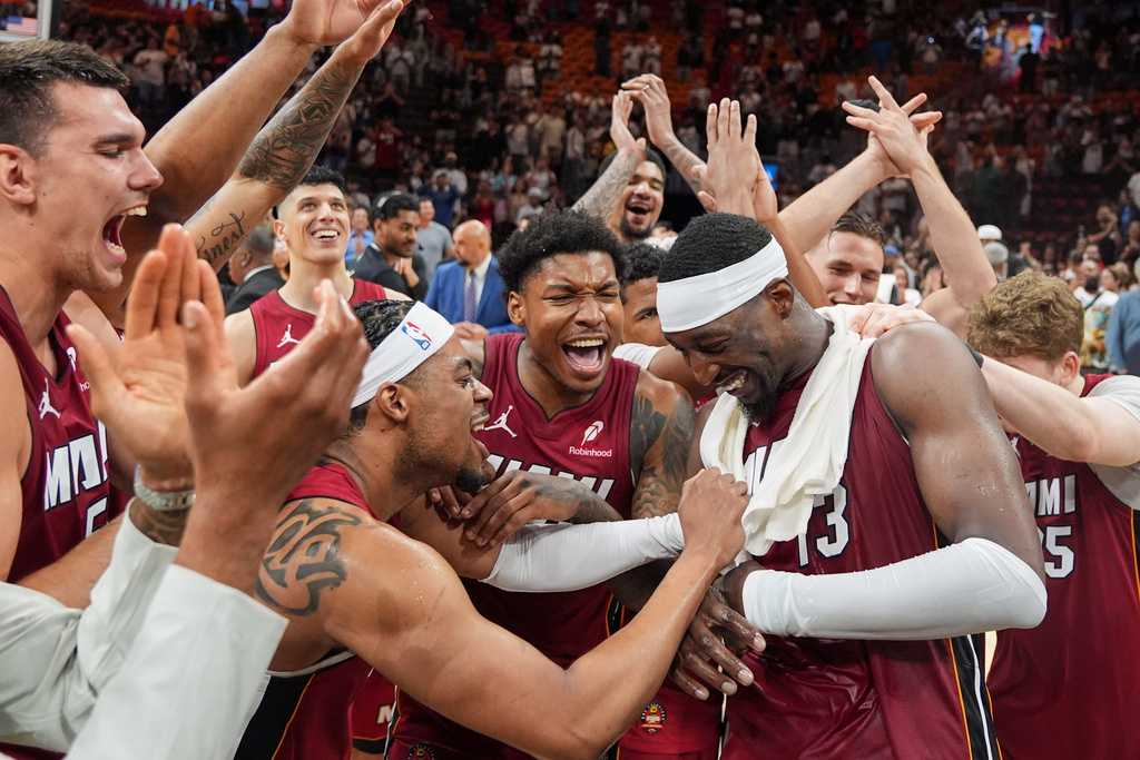 Miami Heat teammates celebrate center Bam Adebayo (13) after he scored 83 points, the second-highest single game total in NBA history, in an NBA basketball game against the Washington Wizards, Tuesday, March 10, 2026, in Miami. (AP Photo/Rebecca Blackwell)