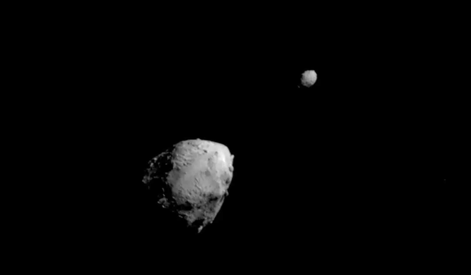 Didymos, left, and Dimorphos are seen just seconds before the DART mission impact.
