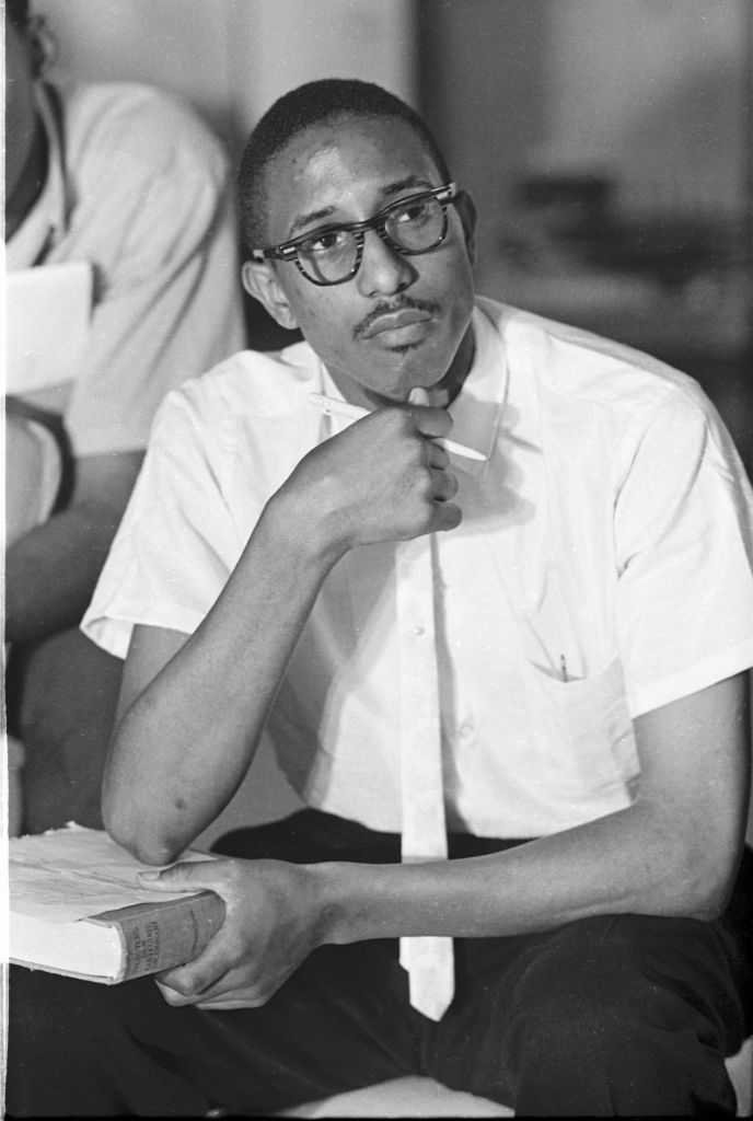View of American Civil Rights activist Bernard Lafayette Jr during a Freedom Riders planning session, Montgomery, Alabama, May 1961. He holds a pen in one hand and a copy of Webster&amp;apos;s New Collegiate Dictionary in the other. (Photo by Lee Lockwood/WSPI/Getty Images)