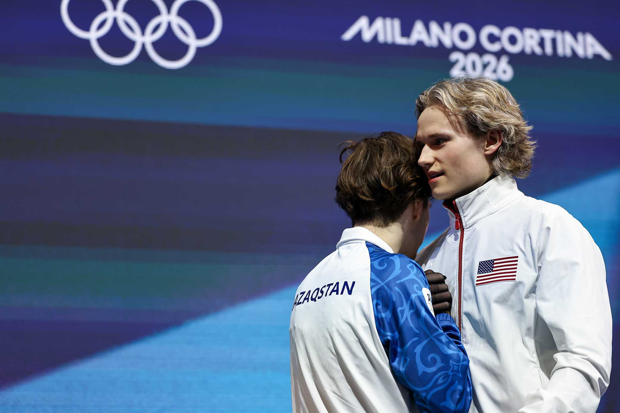 Mikhail Shaidorov of Team Kazakhstan and Ilia Malinin of Team United States embrace following the Men Single Skating on day seven of the Milano Cortina 2026 Winter Olympic Games at Milano Ice Skating Arena on Feb. 13, 2026, in Milan, Italy.