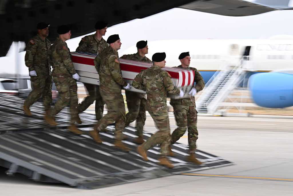 DOVER, DELAWARE - MARCH 07: A U.S. Army carry team moves a flagged-draped transfer case during a dignified transfer at Dover Air Force Base on March 07, 2026 in Dover, Delaware.  Six soldiers from the 103rd Sustainment Command were killed in action by an Iranian drone strike on March 1 in Port Shuabia, Kuwait during &amp;quot;Operation Epic Fury&amp;quot;. (Photo by Roberto Schmidt/Getty Images)