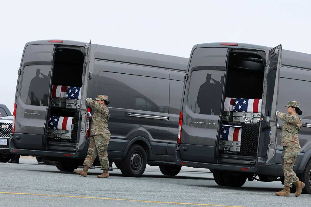 DOVER, DELAWARE - MARCH 07: Members of a U.S. Army carry team prepare to close the doors on a vehicle with flagged-draped transfer cases during a dignified transfer at Dover Air Force Base on March 07, 2026 in Dover, Delaware.  Six soldiers from the 103rd Sustainment Command were killed in action by an Iranian drone strike on March 1 in Port Shuabia, Kuwait during &amp;quot;Operation Epic Fury&amp;quot;. (Photo by Anna Moneymaker/Getty Images)