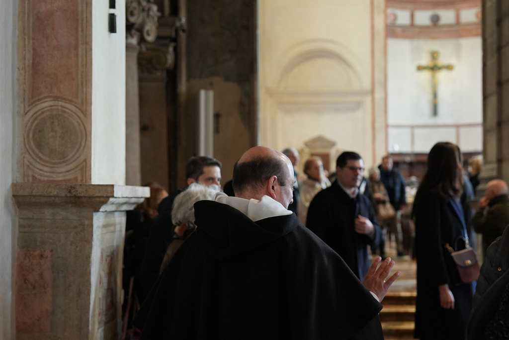 A friar of the Dominican community speaks with visitors in the Basilica of Santa Maria delle Grazie, best known as the home of Leonardo da Vinci&amp;apos;s &amp;quot;The Last Supper,&amp;quot; in Milan, Italy, Sunday, Feb. 15, 2026.