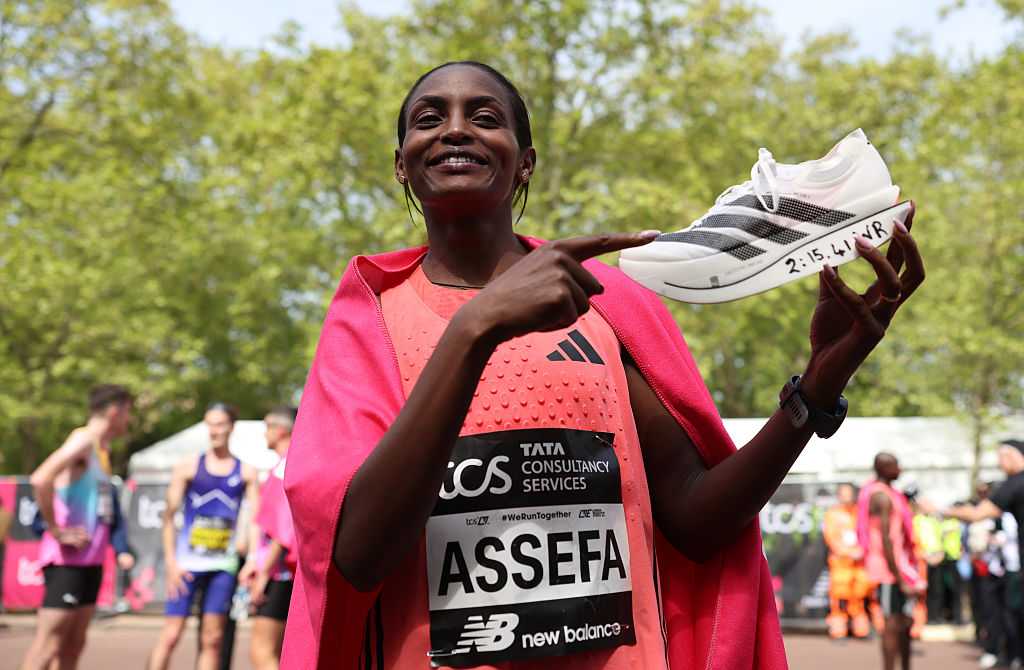 LONDON, ENGLAND - APRIL 26:  Tigst Assefa of Team Ethiopia celebrates with her adidas shoe after winning with a new World Record time during the Women’s 2026 TCS London Marathon on April 26, 2026 in London, England. (Photo by Alex Davidson/Getty Images)