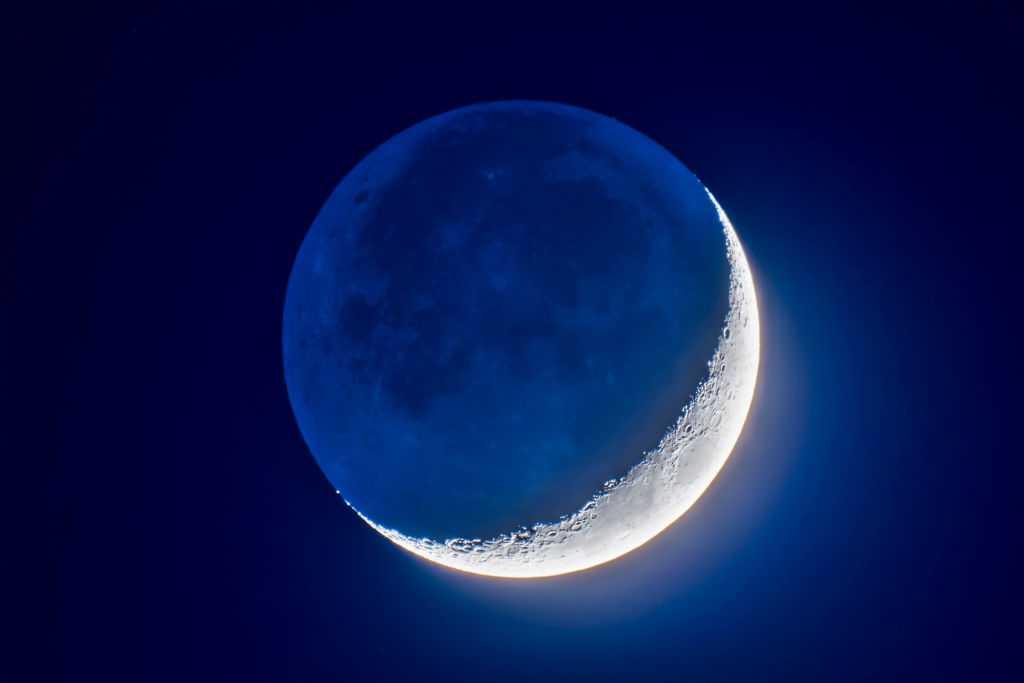The 4-day-old waxing crescent Moon on April 8, 2019 in a blend of short and long exposures to bring out the faint Earthshine on the dark side of the Moon and deep blue twilight sky while retaining details in the bright sunlit crescent.  This is with the 105mm Traveler refractor and 2X AP Barlow lens for an effective focal length of 1200mm at f/12, and with the cropped-frame Canon 60Da at ISO 400,  in a blend of 7 exposures from 1/30 second to 2 seconds, blended with luminosity masks from ADP Pro3 extension panel in Photoshop. (Photo by: Alan Dyer/VWPics/Universal Images Group via Getty Images)