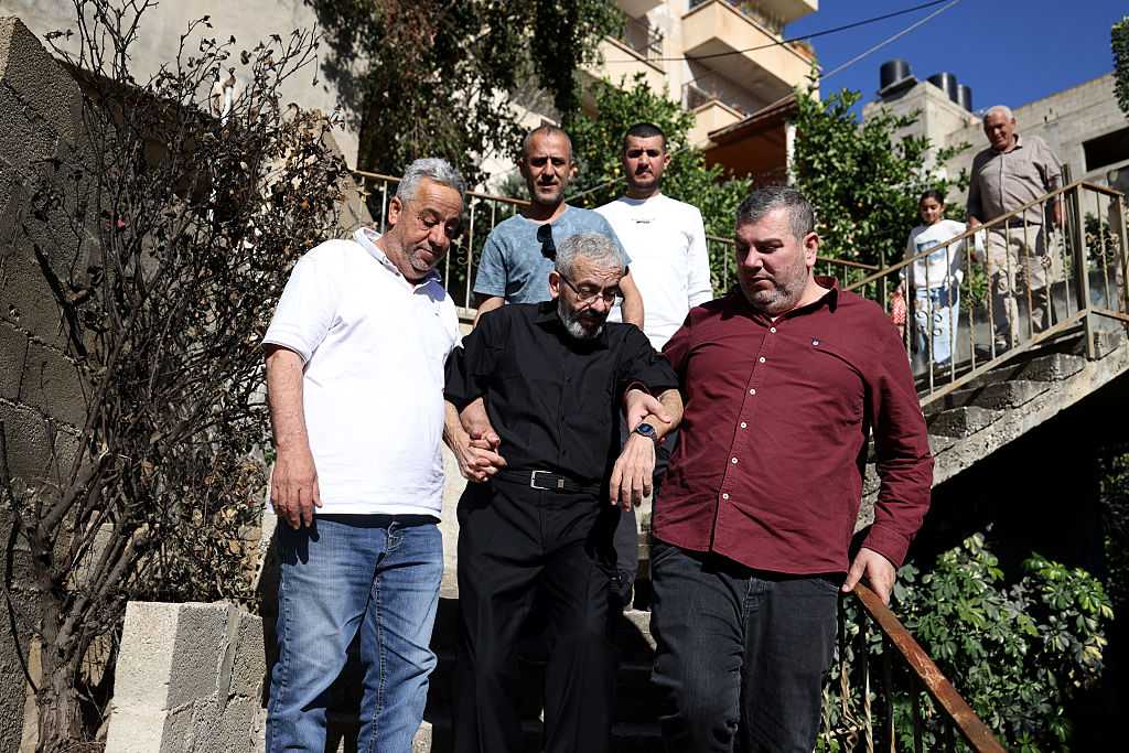 Palestinian journalist Ali al-Samoudi (C) is helped down the stairs at his home in the northern city of Jenin, in the Israeli-occupied Palestinian West Bank on May 1, 2026. Sixty-year-old Al-Samoudi was released following one-year in detention in the Israeli Naqab Prison, located in southern Israel. He was released and checked at the Jenin Hospital where he said, &amp;quot;I was 120 kilogrammes; my weight now is barely 60 kilogrammes&amp;quot;. Israel has jailed an increasing number of journalists since 2023, the year of Hamas&amp;apos;s unprecedented October 7 attack on Israel, which responded with a devastating war in the Gaza Strip. (Photo by JAAFAR ASHTIYEH / AFP via Getty Images)