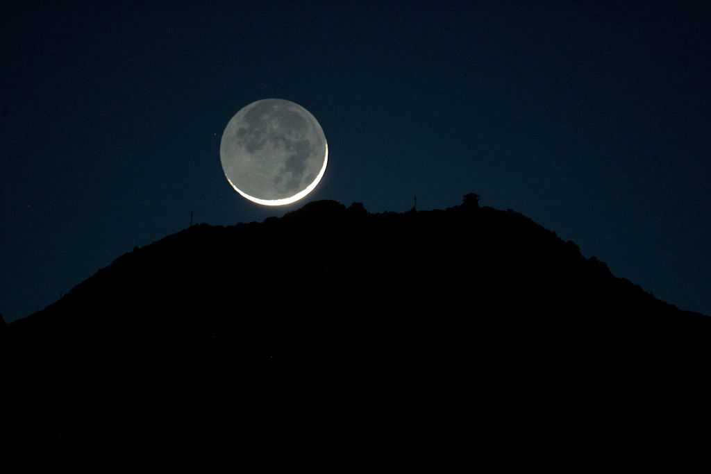 EARTHSHINE_011_fl.jpg  The crescent moon seen from Mill Valley set behind Mount Tamalpais Monday evening as rain clouds from the recent storm made way for a celestial show of earthshine where the earth reflects light from the sun back to the moon.  5/10/05 Mill Valley CA  ;Frederic Larson  ;The San Francisco Chronicle (Photo by Frederic Larson/San Francisco Chronicle via Getty Images)