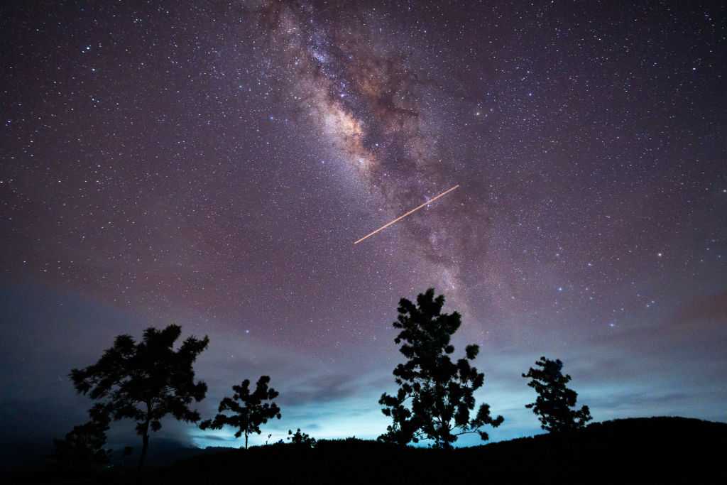 A flight-illuminated path and the Milky Way are appearing in the night sky during the Eta Aquarids meteor shower, which is peaking in Ratnapura, Sri Lanka, on May 5, 2024. The Eta Aquarids Meteor Shower is an annual event caused by Earth passing through debris left behind by Halley&amp;apos;s Comet. Named after the constellation Aquarius, these meteors are streaking across the sky at high speeds, creating a dazzling display of shooting stars. Best observed in the predawn hours away from city lights, it is a mesmerizing celestial event cherished by skywatchers worldwide. (Photo by Thilina Kaluthotage/NurPhoto via Getty Images)