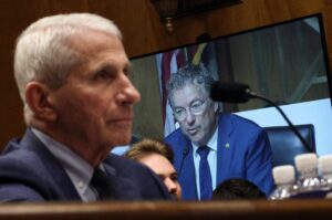 U.S. Sen. Rand Paul, R-Ky., is shown on a monitor as Dr. Anthony Fauci, left, testifies before the Senate Homeland Security and Governmental Affairs Committee on July 29, 2026 in Washington, D.C. (Photo by Kevin Dietsch/Getty Images)