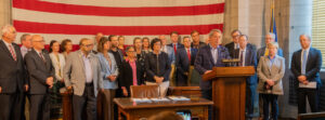 Gov. Jim Pillen and more than two dozen lawmakers join for a news conference celebrating the passage of a much narrowed property tax relief package